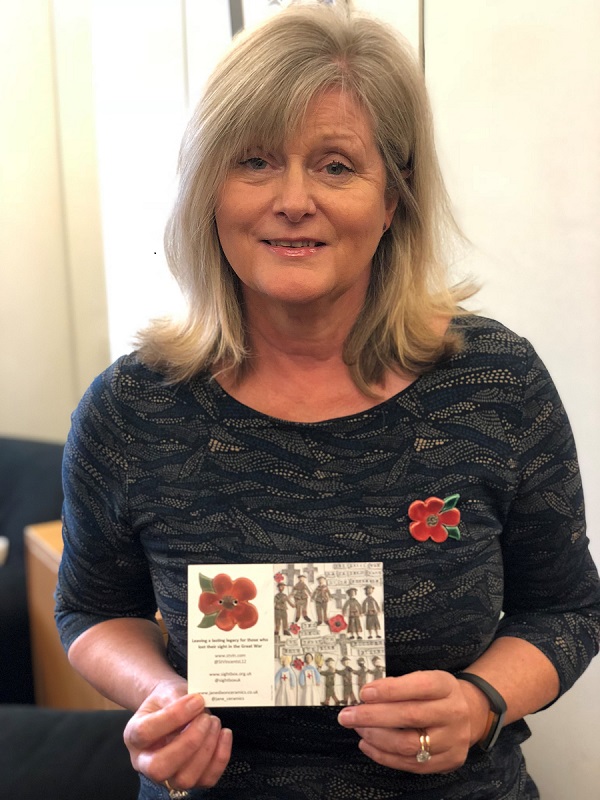 Anne Main MP with the ceramic poppy run by St Vincent's School